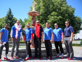 RBC Royal Bank employees show off their heels at the Men in Heels and Lunch on Wheels event at Museum Square in Woodstock on Thursday. (Chris Funston/Sentinel-Review)
