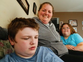 Luke Hendry/The Intelligencer
Ashley Wright sits with her son, Logan, 13, who has autism spectrum disorder, and daughter, Brinlee, 11, at their home Thursday in Belleville. Wright's received hundreds of encouraging messages after a stranger accosted them about Logan's behaviour during a trip to a zoo. Wright wrote an open letter to the man which has since been shared online thousands of times.