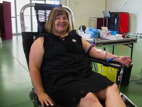 Michelle Benjamin donates blood for the 50th time at the Paris fairgrounds during a blood drive earlier this week. (Alex Vialette/The Expositor)
