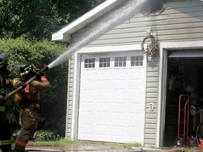 Firefighters respond to a garage fire at 100 Eastern Ave., on Thursday, June 14, 2018.