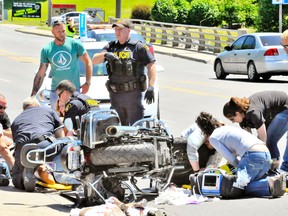 A man and a woman on a motorcycle were injured Friday when they collided with a pizza delivery vehicle in the westbound lane of the Queensway East in Simcoe in front of Tim Hortons. The crash occurred over the noon hour. Paramedics took the pair to hospital on stretchers. MONTE SONNENBERG / SIMCOE REFORMER