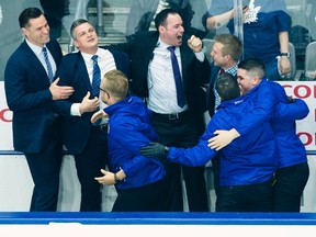 Toronto Marlies head coach Sheldon Keefe, second left, celebrates with his coaching and training staff after defeating the Texas Stars to win the AHL Calder Cup championship in Toronto on Thursday, June 14, 2018. THE CANADIAN PRESS/Nathan Denette