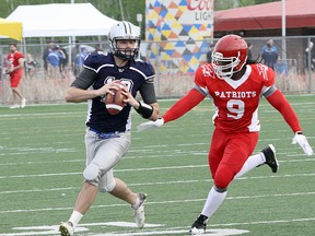 Sudbury Spartans quarterback Hunter Holub (12) looks to make a pass while evading Steel City Patriots defender Switchson Spring during Northern Football Conference action at James Jerome Sports Complex in Sudbury on Saturday, May 26, 2018. Ben Leeson/The Sudbury Star/Postmedia Network
