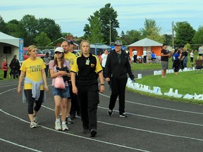 BEN COHEN/Sault Star  
Rocky DiPietro Track transformed Friday night as hundreds gathered to support Relay for Life, an annual fundraising event for the Canadian Cancer Society that place between 7 p.m. Friday until 1 a.m. Saturday, Relay for Life featured a DJ, bands playing around the field and numerous food vendors. Pictured here are people marching around the track an hour-and-a-half into the fundraiser.