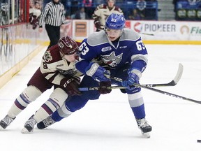 Jake Partridge of the Peterborough Petes battles for the puck with Liam Ross of the Sudbury Wolves during OHL action in Sudbury, Ont. on Sunday March 11, 2018. Gino Donato/Sudbury Star/Postmedia Network