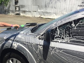 Nina Zaychuk washes a car during Krown's fundraiser for the Children's Wish Foundation on Saturday. CHRISTIAN PAAS-LANG / THE NUGGET