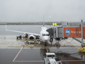 An inbound flight unloads passengers at the Fort McMurray International Airport on Monday, June 9, 2014. Supplied Image/Fort McMurray Airport Authority