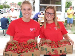 Ally Glaves (left) and Sierra DeMaere from Wholesome Pickin’s strawberry farm showed off the June berry batch at the Delhi Strawberry Festival on Saturday.
Susan Gamble/The Expositor