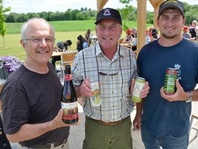 The Apple Pie Trail Ciderfest concluded 10 days of cider-tasting at area ciders on Sunday. At Georgian Hills Vineyards, home to Ardiel Cider House, business partners Robert Ketchin, left, John Ardiel, and his son, Greg Ardiel, hold four ciders containing alcohol, made from Ardiel-grown-apples, on Saturday. (Scott Dunn/The Sun Times)