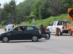 An OPP officer directs traffic at a detour on Highway 17 at Main Street in North Bay, Sunday afternoon. A multi-vehicle crash closed the highway until about 10 p.m. tonight.
PJ Wilson/The Nugget