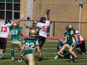 Brantford Bisons junior varsity players Keegan Runge (33) and Joshua Rietveld (54) attempt to block a pass from Forest City Thunderbirds quaterback to Nathan Hicks on Saturday during a game a football game at the Bisons Almuni North Park Sports Complex.
ALEX VIALETTE/THE EXPOSITOR