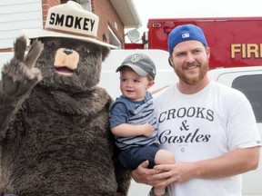 Toddler Lukas D’Alessandro doesn’t look at all ruffled about getting up close and personal with Smokey the Bear, aka Robert Eshkibok, of the MNR’s Fire Management Headquarters in Chapleau. Lukas was visiting the pavilion opening gala with his father, Matt D”Alessando.