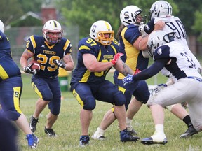 Running behind the blocks of Jordan Bruyere (left) and Nate Edwards, Josh Gauthier looks for a hole on Saturday at Rocky DiPietro Field. Gauthier scored a pair of touchdowns as the Sault Steelers defeated the Sudbury Spartans 23-10 in Northern Football Conference action. (Peter Ruicci/Postmedia Network)