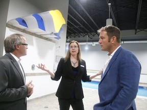 Michelle Wolfe-Bayard, general manager of the Microtel Inn & Suites Sudbury, chats with owner Luc Sergerie and Eric Watson, master developer for Microtel and investor, at the grand opening of the new hotel in 2016. The city is considering imposing a hotel tax of four per cent that could come into effect in September. (Gino Donato/Sudbury Star file photo)