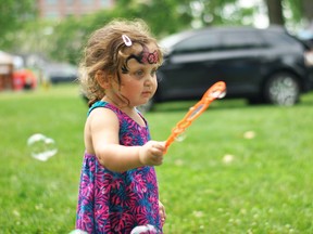 Little Helen Lambert plays with bubbles in Tecumseh Park during CK Summer Fest Saturday. Tom Morrison/Chatham This Week