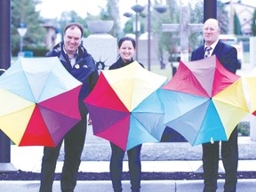 From left to right: Coun. Bill Hamilton, Coun. Laura Tillack, and Mayor Bob Young show off colourful umbrellas at the City of Leduc's rainbow flag raising event held this past Monday, June 11. (Kyra Bird/Rep staff)