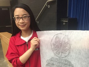 BCI student Jeriann Hsiao holds a rubbing of the headstone of Lieut. John Percy Orr, a BCI student who was killed in the First World War. (Vincent Ball/The Expositor)