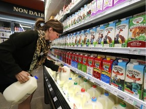 In this file photo, grocery and dairy assistant Reyna DeLoge stocks dairy products at Vitamin Cottage
Natural Grocers in Denver.
