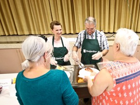 Line Hache, director of sales support at Desjardins Voyageurs Credit Union, and Robert Boucher, president of the board of directors at the credit union, helped to serve more than 1,000 pancakes on June 17. Supplied photo