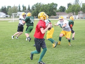 A Melfort Comets’ quarterback goes back to pass and faces a relentless pass rush during an offense on defense drill at Melfort Comets’ Spring Camp on Saturday, June 16.