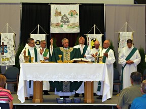 Bishop Ronald Fabbro (centre) celebrates a mass Sunday for all Catholic churches in Norfolk County held at Holy Trinity Catholic High School in Simcoe. SUSAN GAMBLE/Postmedia news