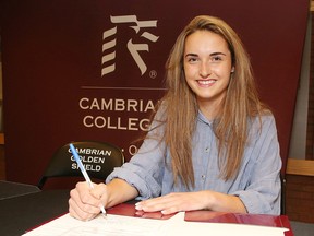 Sydney Tarini signs to be a member of the Cambrian Golden Shield women's cross-country running team at a recruit signing in Sudbury on Monday. Cambrian College Golden Shield recruited 20 new athletes. Gino Donato/Sudbury Star/Postmedia Network
