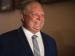 Ontario Premier-designate Doug Ford speaks to the media during a break from the first meeting of the newly-elected Ontario PC Caucus at Queen's Park in Toronto on Tuesday, June 19, 2018. THE CANADIAN PRESS/ Tijana Martin