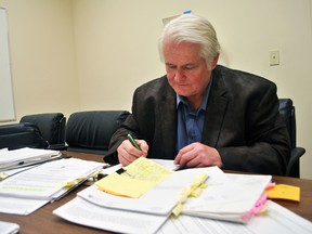 Chatham man John Cryderman is shown June 15 with documents related to a Freedom of Information request he won against the Municipality of Chatham-Kent regarding financial information about a proposed amalgamation of fire and paramedic services. Tom Morrison/Chatham This Week