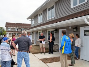 Owen Sound Mayor Ian Boddy, in black blazer, speaks during a tour Tuesday afternoon of the Owen Sound Housing Company's new Odawa Heights development. DENIS LANGLOIS/THE SUN TIMES