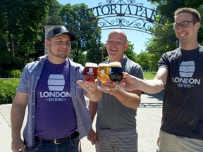London Brewing Co-op worker owners Jeff Pastorius (left) and Aaron Lawrence flank Doug Hillier, president of Family Shows Canada, at the northwest corner of Victoria Park. Craft beer has become a staple at local festivals and trade shows and pairs well with the International Food Festival this weekend. (CHRIS MONTANINI\LONDONER)