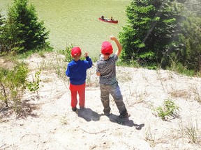 A pair of campers at Camp Attawandaron wave at a passing canoe. Camp committee members of the Bluewater Area Scouting group are attempting to raise $132,000 in order to purchase 12 modern, all-season cabins for the camp.
Handout/Sarnia This Week