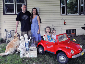 Craig and Melanie Kernaghan, shown with their children Sophia, 4, and Robinson, 1, and their dog Daisy, were chatting with two neighbours at their home in the Tillsonburg-area town of Courtland on Monday afternoon when lightning struck. Melanie Kernaghan says her heart stopped and she was knocked unconscious. JACOB ROBINSON/Postmedia Network