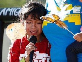 In this Monday, June 18, 2018 file photo, Akemi Vargas, 8, cries as she talks about being separated from her father during an immigration family separation protest in front of the Sandra Day O'Connor U.S. District Court building in Phoenix. Child welfare agencies across America make wrenching decisions every day to separate children from their parents. But those agencies have ways of minimizing the trauma that aren't being employed by the Trump administration at the Mexican border. AP Photo/Ross D. Franklin, File