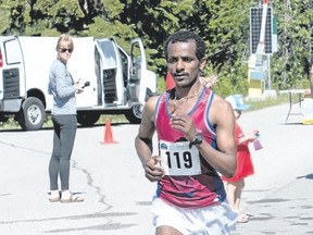 Banff resident Daniel Habteyes runs along the Bow Valley Parkway on his way to first place in the full Banff Marathon on Sunday.