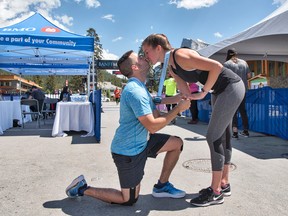 Kevin Tessier proposes to his fiance Andrea Zeiler, both from Calgary, at the finish line of the Banff Marathon on Sunday, June 17, 2018. The couple ran the full marathon together and he proposed at the finish line at Central Park in Banff.