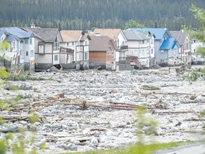 Several homes and lots on the east side of Cougar Creek in Canmore were severely damaged and backyards were swept away by flood waters in June 2013.