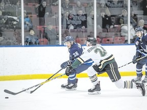 Jacob Bernard-Docker (front) stretches to keep the puck away from Canmore Eagles’ Max Giangualano during an AJHL game on March 1 between the Eagles and the Okotoks Oilers. The Canmore-born Oilers defenceman is expected to be selected in either the first or second round of this week’s NHL Entry Draft, which takes place Friday and Saturday.