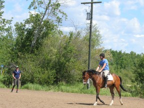 Ray Nikiforuk riding Bankin the Gold under the watchful eye of clinician Leah Southward. Southward kept up a steady stream of suggestions and encouragement to riders as she watched them.