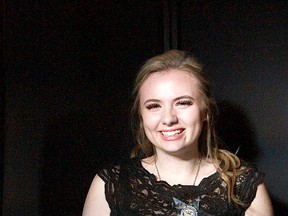 Strathcona Christian Academy student Joelle Bragge shows off her award for Outstanding Performance by a Featured Actress in a Musical.