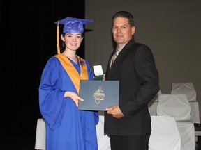 ECJV graduating student and class valedictorian Emilie Godin receives her diploma from Principal Steve Guertin.