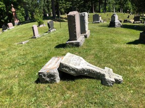 BRUCE BELL/THE INTELLIGENCER
A monument lays on the ground in Picton’s Glenwood Cemetery on Thursday morning. Vandals damaged approximately 200 headstones, monuments and urns on the 62-acre property late Wednesday afternoon or early evening.