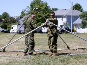 Mast. Cpl. Rob Halls and Cpl. John Braunisch, members of the 22 Wing Canadian Forces Base North Bay erect a tent in preparation for Relay for Life. The annual Canadian Cancer fundraiser kicks off Friday at 6 p.m. with opening ceremonies and a survivor lap.