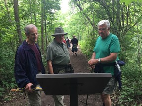 Tom d’Entremont, left, Bob Johnstone and Jim Northey read one of the new educational signs installed along the restored Old Growth Forest Trail, one of the loops in the Dan Patterson Trail. Kettle Creek Conservation Authority celebrated the reopening of the trail Wednesday. (Laura Broadley/Times-Journal)