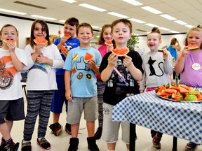 Students snack on fruits and veggies at London's Woodland Heights public school, one of many schools participating in the region's Ontario Student Nutrition Program. The program is designed to give in-need students a healthy option to start the day. Students include, from left, Jacob Tangen, Kayla Morris, Thomas McGregor, Kaden Hadley, Olivia Horne, Periden Brockett, Chloe Cook, and Hannah Curtis. (Louis Pin/Postmedia News)
