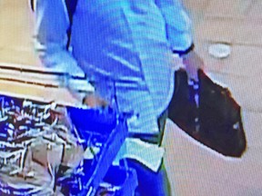A man suspected of stealing a wallet and using a woman's credit card to make multiple purchases in Kingston, Ont. in May. Supplied photo