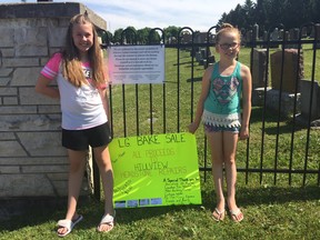 Lilly Foord-Davis, left, with best friend Gracelyn Davidson Boscariol are hosting a bake sale Saturday to raise money for repairs to Hillview Cemetery. (HEATHER RIVERS/SENTINEL-REVIEW)