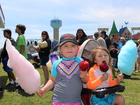 Beatrice Black, 4,  and her three-year-old brother, Hendrix, stock up on treats Thursday at Solidarity Day on the grounds of Six Nations Community Hall. (Michelle Ruby/The Expositor)