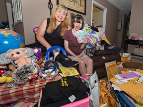 Nicole Callander and her daughter, Kaitlin, show some of the cards and items sent to the girl for her 18th birthday on July 11. Callander has organized an "unbirthday birthday party"  for Kaitlin and about 200 other kids next month in Mohawk Park. (Brian Thompson/The Expositor)