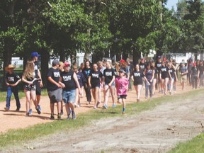 Participants take part in the first lap together of the Relay for Life June 8 at the J.T. Foster High School track. Ian Gustafson Nanton News