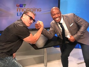 Mixed martial arts icon Ken Shamrock, left, arm wrestles former Canadian Football League star Henry Burris, during a media appearance on CTV in Ottawa earlier this month. Burris is one of the hosts of CTV Morning Live. (Jan Murphy/The Whig-Standard)